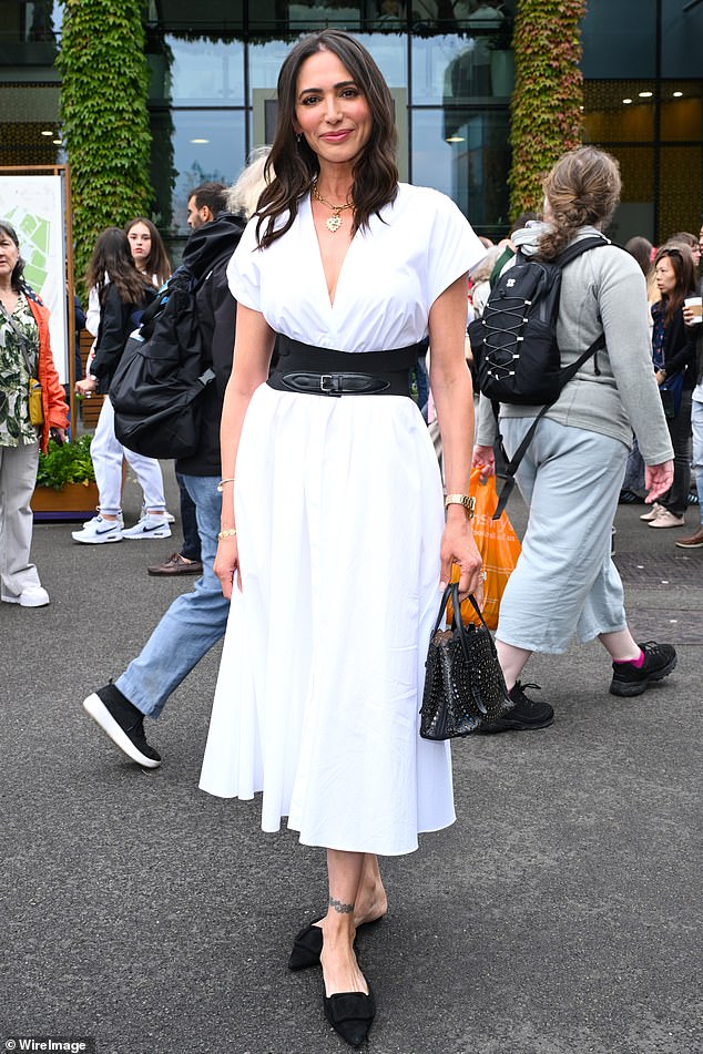 Lauren Silverman, meanwhile, stuck to tennis white, looking chic in a midi dress with a black belt that cinched in her waist