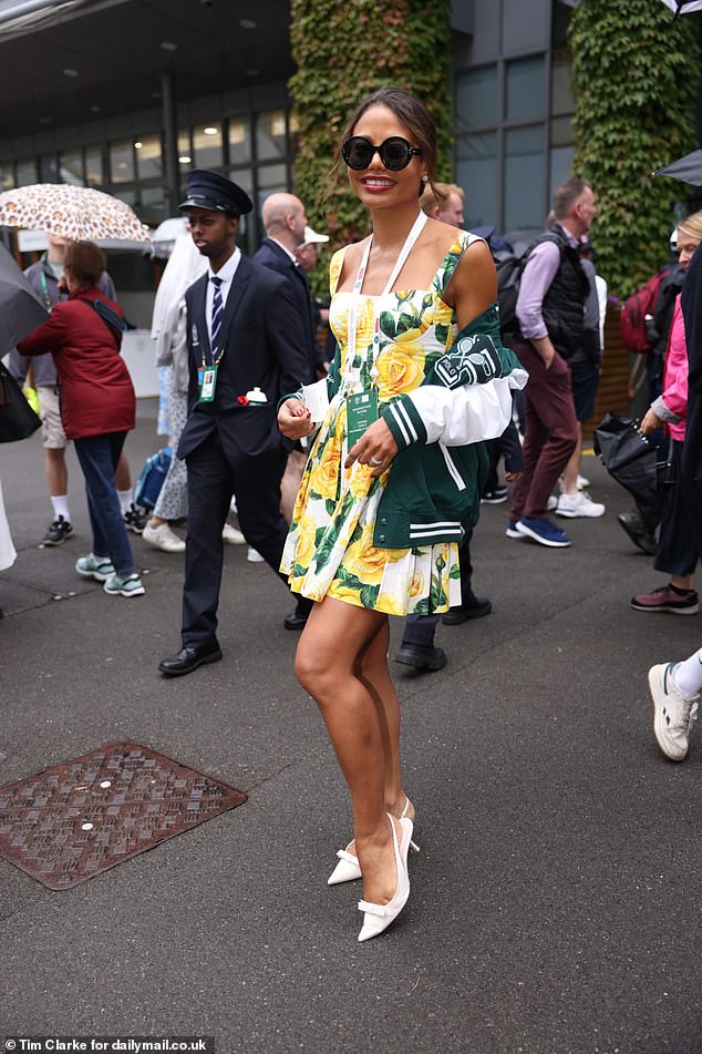 Emma Weymouth dazzled in a floral print mini dress and wrapped a tennis jacket around her to stay warm