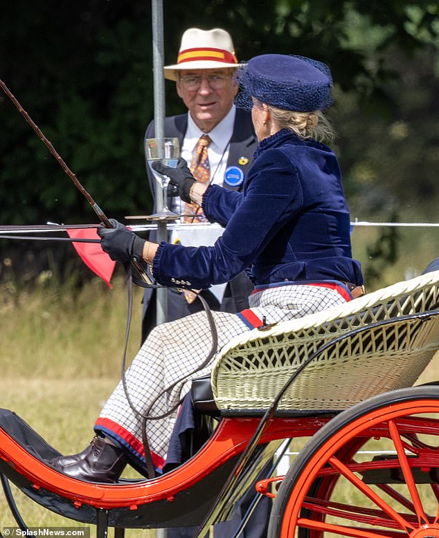 Sophie looked elegant in a navy velvet jacket by Laurie & Jules, a sapphire blue net hat by Jane Taylor London, a checked white maxi skirt and tan boots