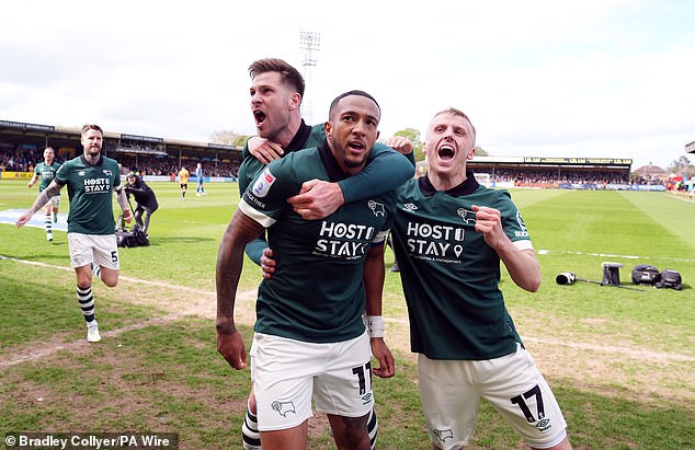 Derby County's Nathaniel Mendez-Laing celebrates scoring his team's first goal of the match with team-mates during the Sky Bet League One match at Cledara Abbey Stadium in Cambridge. Date of photo: Saturday 20 April 2024