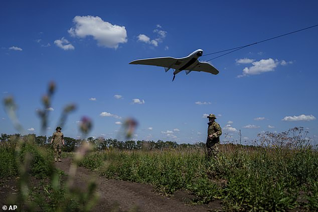 Ukrainian soldiers from the Ochi reconnaissance unit launch a Furia drone to fly over Russian positions on the front in Donetsk