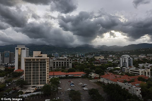 Storm clouds hang over the mountains as people make final preparations for the arrival of Hurricane Beryl on July 3, 2024 in Kingston, Jamaica