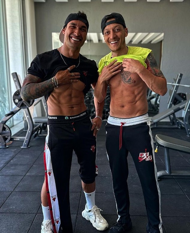 Ozil works with a personal trainer to build serious muscle mass