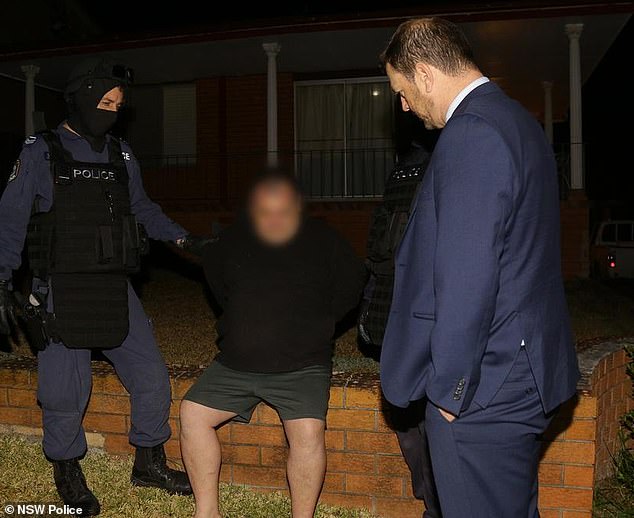 Rebels member Colin Crane (pictured during his arrest in 2018) has had his murder conviction quashed