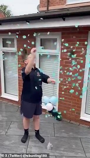 In the video, Bunting's son Tobias pops a giant balloon, releasing blue confetti, indicating they are expecting a boy