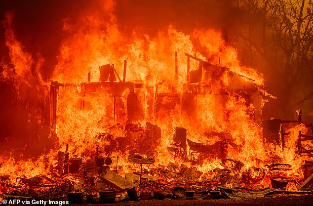 Flames destroy a home during the Thompson Fire in Oroville, California on July 2, 2024