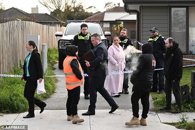 Preliminary forensic examination has revealed that all four individuals had a synthetic opioid in their system (pictured are family and police present at the home where the four bodies were found)