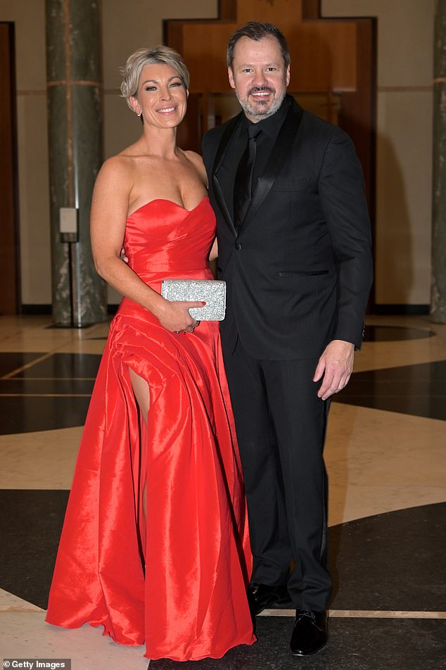 Industry and Science Minister Ed Husic's fiancée Fiona Scott made a fashion blunder in a long red strapless dress, with bizarre detailing on the daring slit