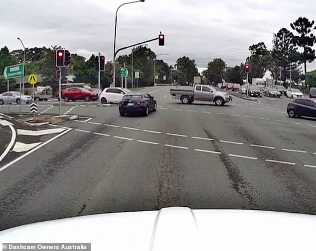Mr Pastor's dashcam footage captured the moment a blue Mazda hatchback raced through a red light and onto the road (photo)