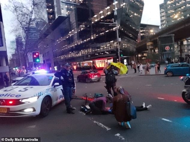 Bystanders and police helped the woman while she waited for emergency services to arrive