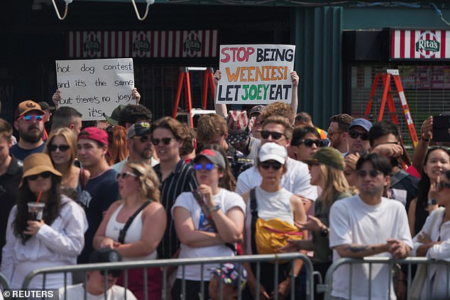 Fans held up cardboard signs to express their disapproval of Chestnut's exclusion this year in NYC
