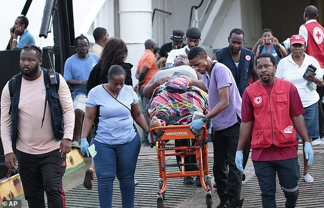 Red Cross members carry an evacuee from Union Island on a stretcher upon arrival in Kingstown, St. Vincent and the Grenadines