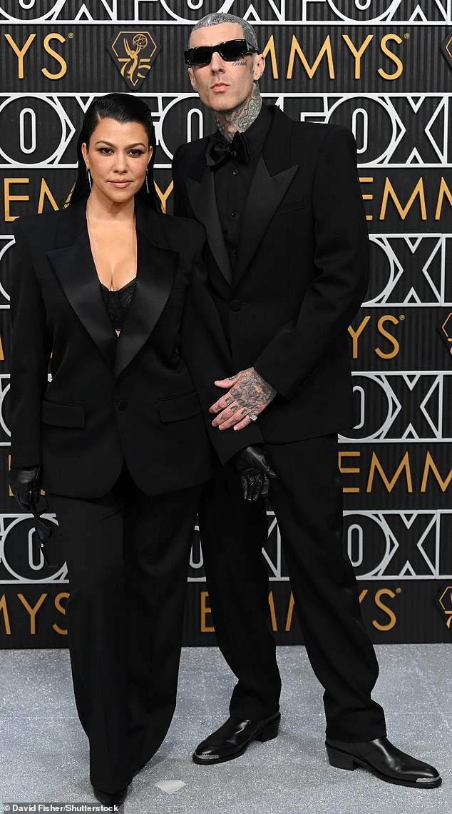 At this year's Emmy Awards, Kourtney wore a black pantsuit with satin detailing, as her husband, Travis Barker, matched her