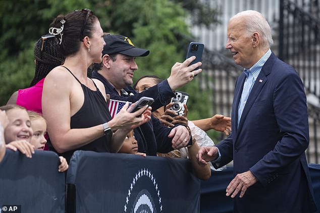 President Joe Biden poses for photos after delivering a short speech to military personnel and their families on July 4