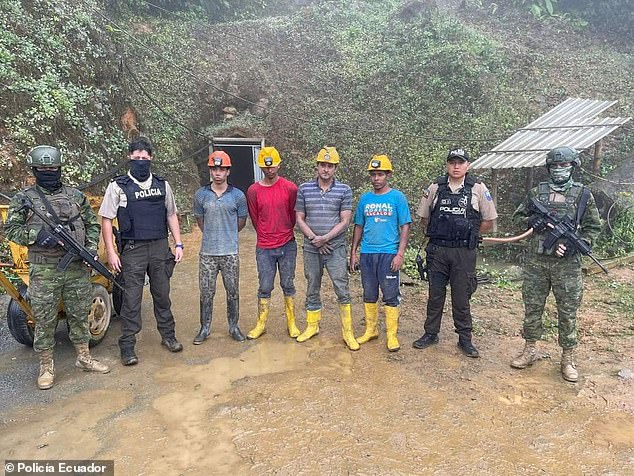 Ecuadorian soldiers and police guard four of the 49 miners rescued on Wednesday