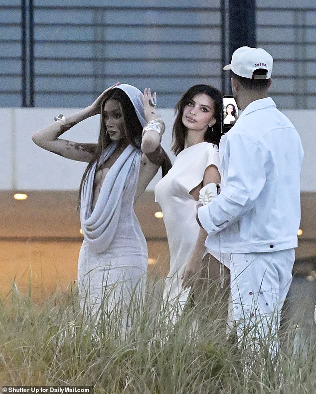 Among them was Emily Ratajkowski, seen here center, arriving before sunset with girlfriend Winnie Harlow