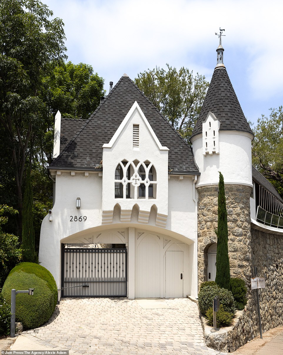 The house, together with the outbuildings, is complete with turrets, coffered ceilings and the original windows from the turbulent twenties