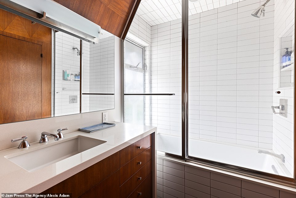 The metro tiles throughout the bathroom provide a luxurious and elegant look