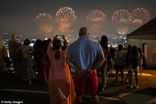 A view of a couple watching the 48th annual Macy's 4th of July fireworks display in New York City, as seen from Weehawken New Jersey