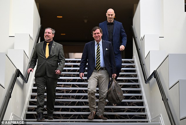 Carlson (centre) arrives to speak at the Australian Freedom Conference at the Hyatt Hotel Canberra