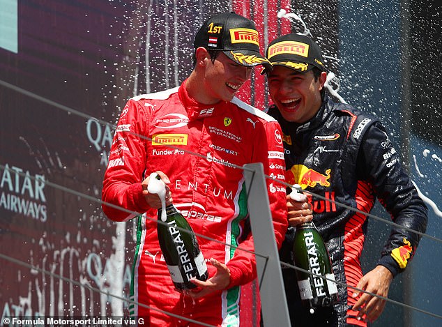 Bearman celebrates next to Josep Maria Marti (right) after winning a Formula 2 race in Austria