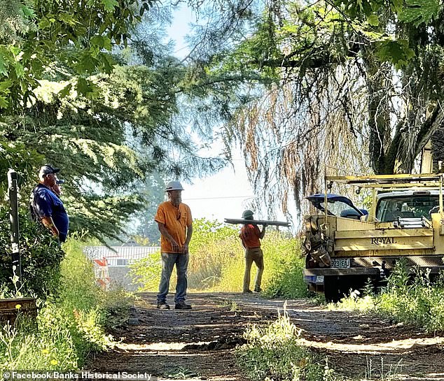 Members of the demolition crew are seen at the site on Friday