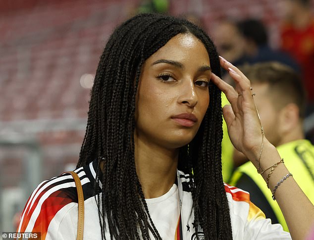 Florian Wirtz's girlfriend Aaliyah looked at a photographer while wearing a German shirt