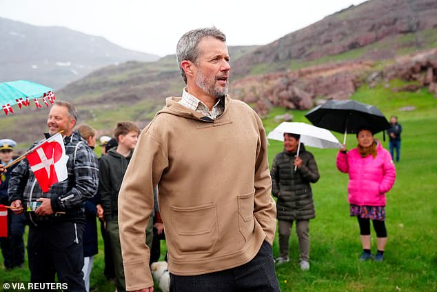 The couple initially wore matching sweaters - Mary's in a dark green color and Frederik's in a khaki color - but took them off as temperatures warmed