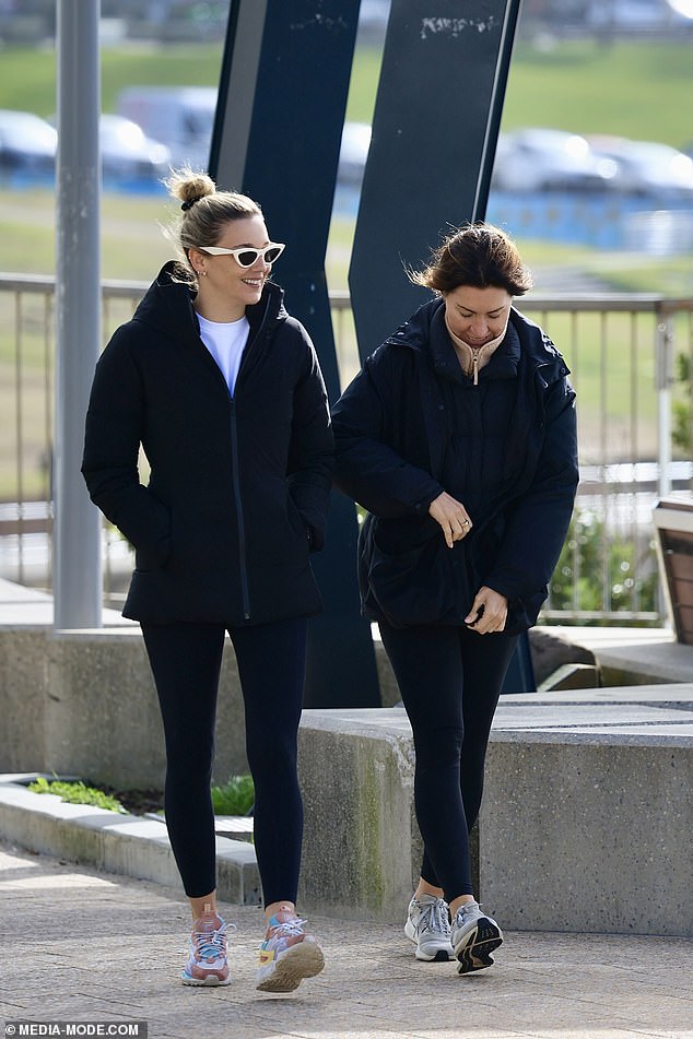 She wore a white top underneath, and added a pair of black tights and colorful sneakers