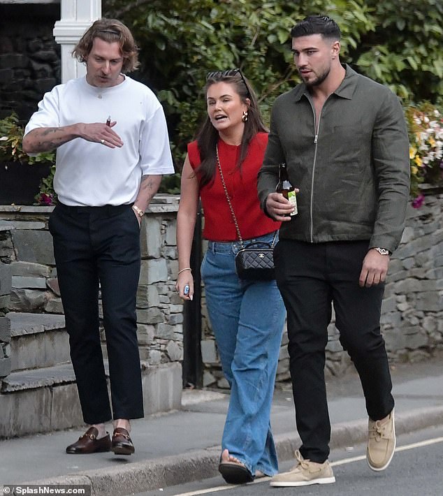 He teamed the smart casual ensemble with a pair of beige boat shoes and was photographed leaving the boat trip with a bottle of cider in his hand.