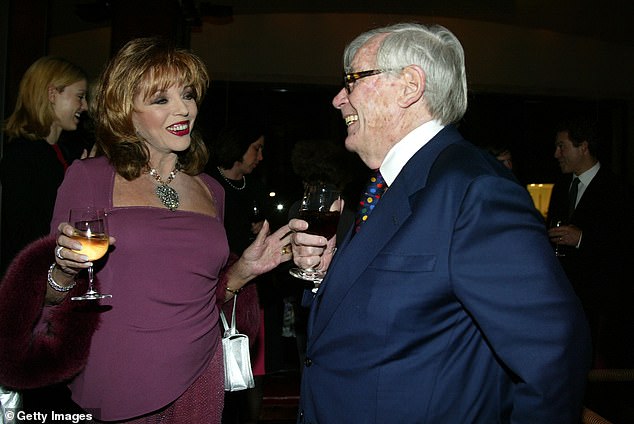 Dominick Dunne shares a laugh with Joan Collins at a party in New York