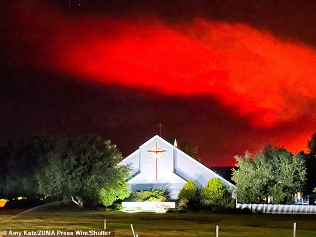 In Santa Ynez, a church stands tall in the backdrop of the looming Lake Fire