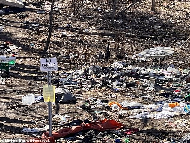 There is a 'no camping' sign in front of the waste