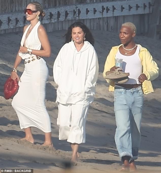 She was also surrounded by friends, with whom she was spotted enjoying a stroll on the beach during the sultry California summer.