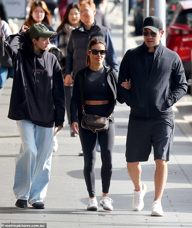 The Logie Award nominee hid her eyes behind dark sunglasses as she showed off her toned stomach under a black crop top and tights