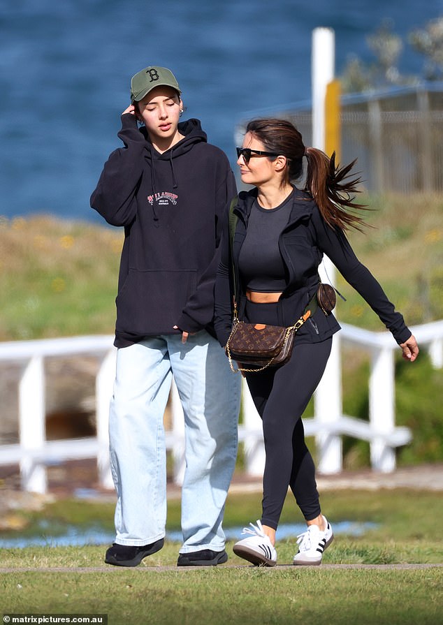 The preteen kept her dark locks tucked under a green cap and was later seen saying goodbye to Ada and her father as they headed out for lunch at Mimi's