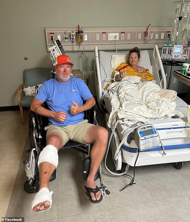 Tabatha Sullivent sits in a hospital bed after her calf was bitten off by a bull shark. Her husband, who bravely fought the beast, sits next to her