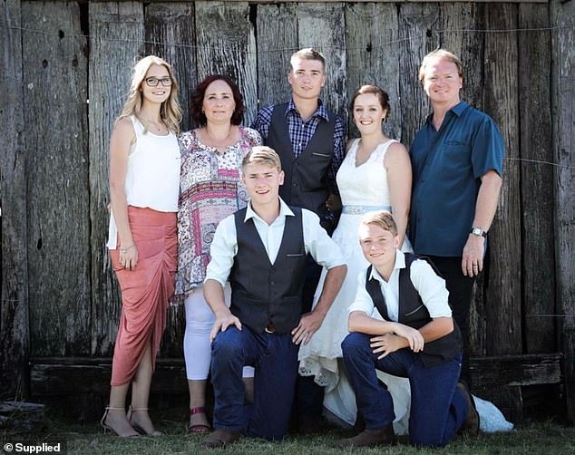 Olivia is pictured with her older brother Chris (who is standing next to his wife Stefanie Harlow), her father David, her mother Jill and two younger brothers Scott and Ryan