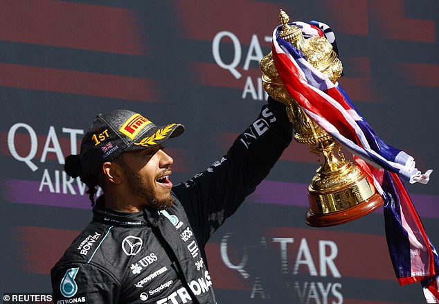 Hamilton looked delighted as he held up his trophy, which was wrapped in a Union Jack flag