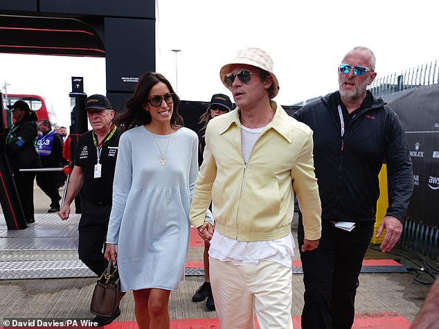 Ines looked stunning in a breezy light blue dress and boots, while Brad stood out from the crowd in a yellow jacket and a quirky bucket hat