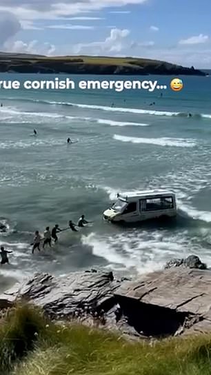 Beachgoers try to tow away van