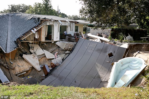 A home is destroyed after the backyard behind the house collapsed and became a sinkhole, taking with it their deck and boat in November 2013 in Dunedin, Florida