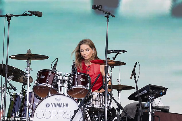 Drummer Caroline, 51, wore a red leather vest as she took to the stage