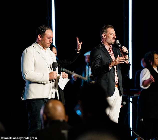 Lassey is pictured on the right as he prays on stage during a Kingdom City Church meeting