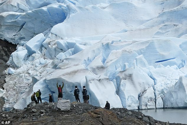 A group of people enjoy the view of the Mendenhall Glacier on June 8, 2023, near Juneau