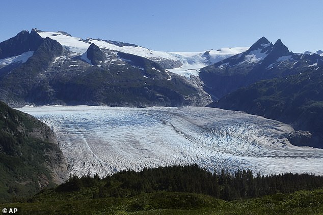 The face of the Mendenhall Glacier is seen from the Mount McGinnis trail in Juneau on Sunday, August 20, 2023. The glacier overflows into Mendenhall Lake