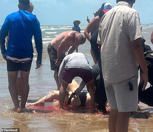 Sullivent is seen falling into the ocean bleeding from her leg as the group that pulled her from the water surrounds her