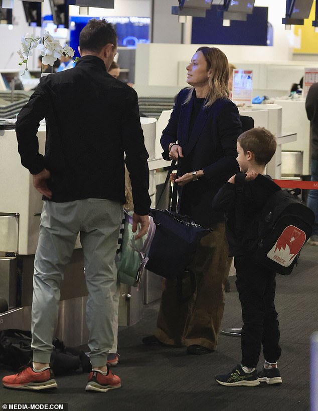 The 45-year-old A Current Affair presenter was spotted checking in for an international flight at Sydney Airport with her husband Michael and their children Mack, seven, and Scout, four.