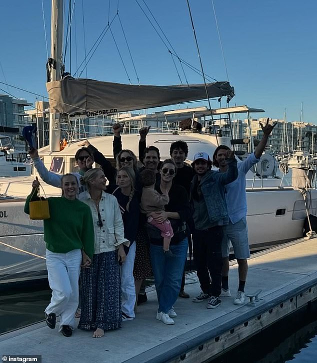 The family stopped for a group photo on the dock next to the boat