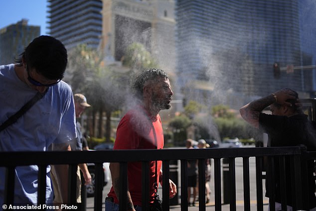 People seek relief in mist along the Las Vegas Strip on Sunday